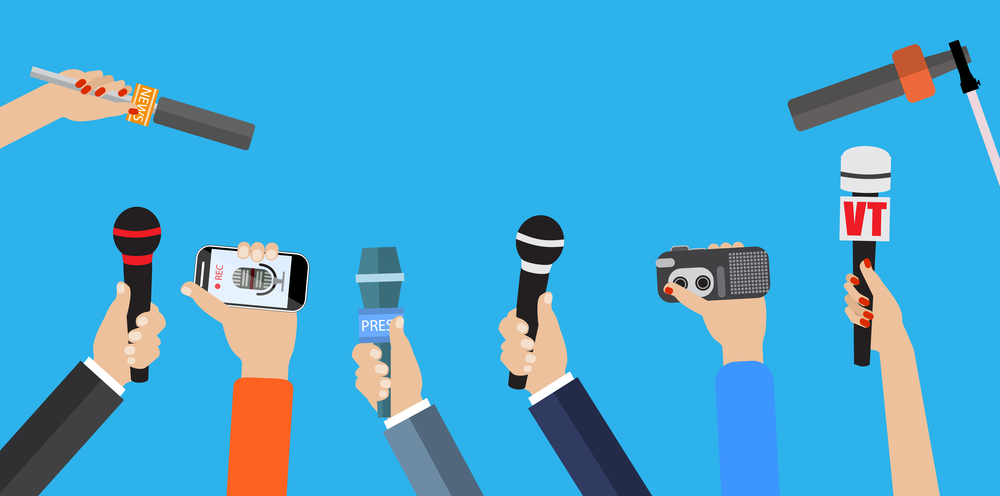 Set of hands holding microphones.